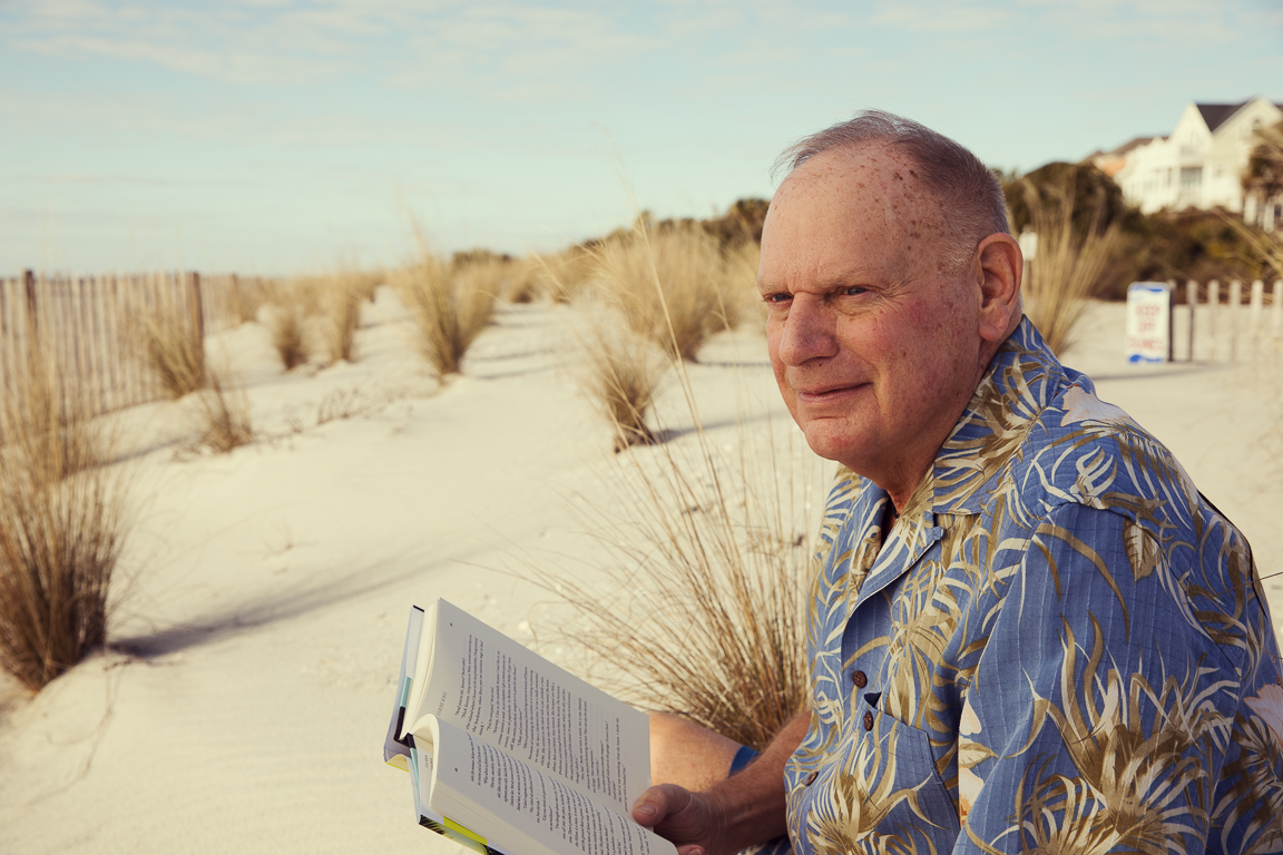 elderly man reading book on beach in charleston south carolina brandon clifton atlanta portrait and lifestyle photographer