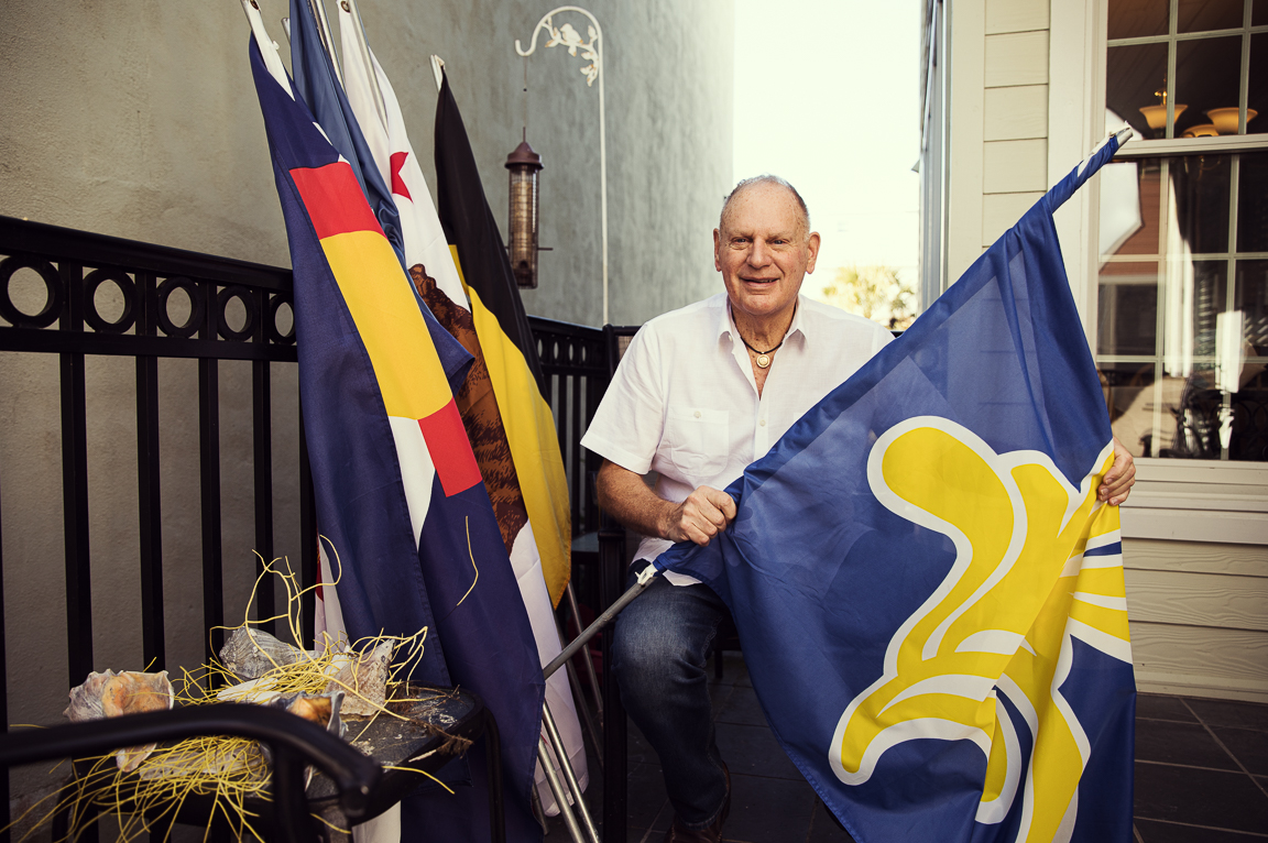 elderly man holding flags on back porch brandon clifton atlanta portrait and lifestyle photographer
