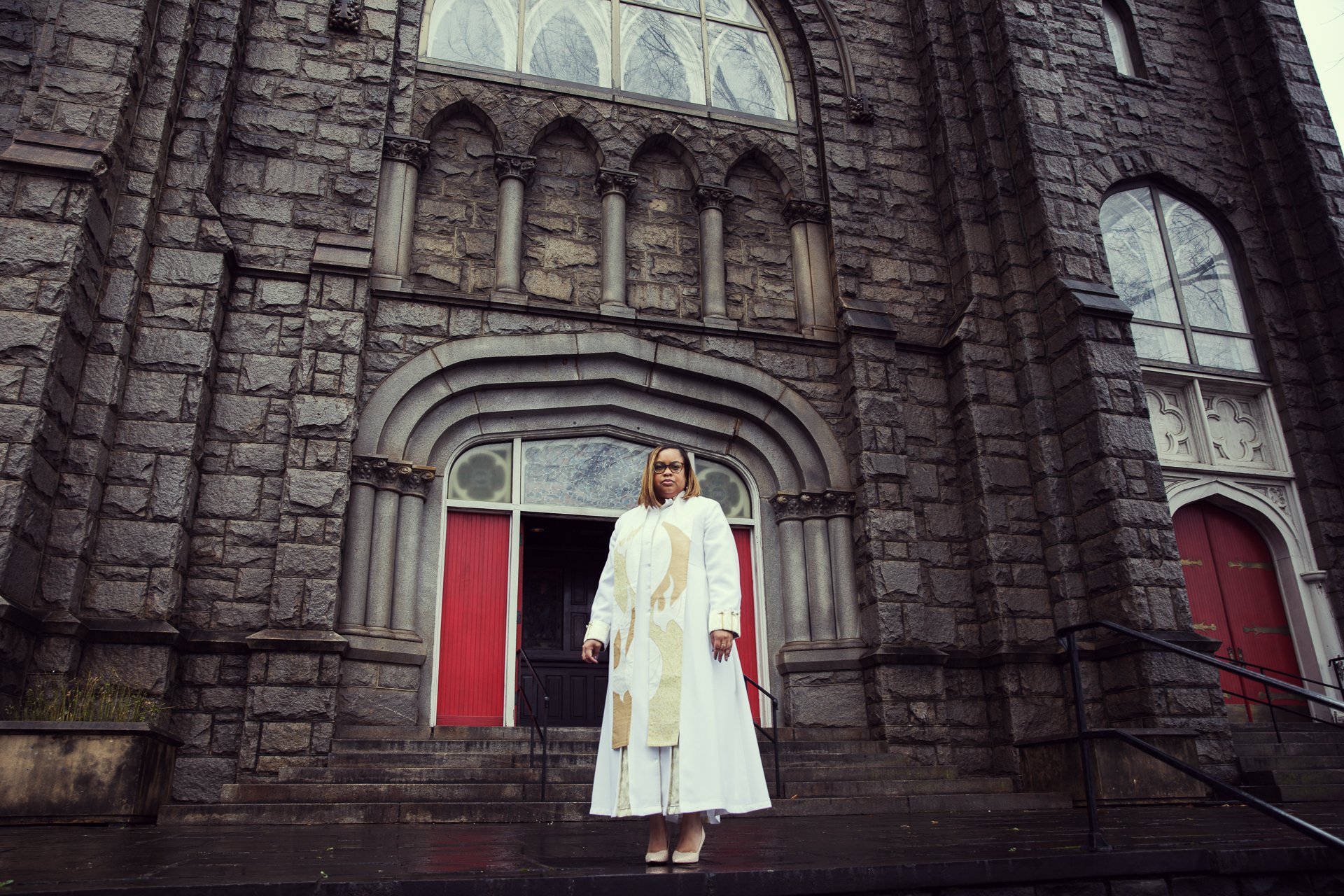 female reverend standing in front of her church brandon clifton atlanta photographer