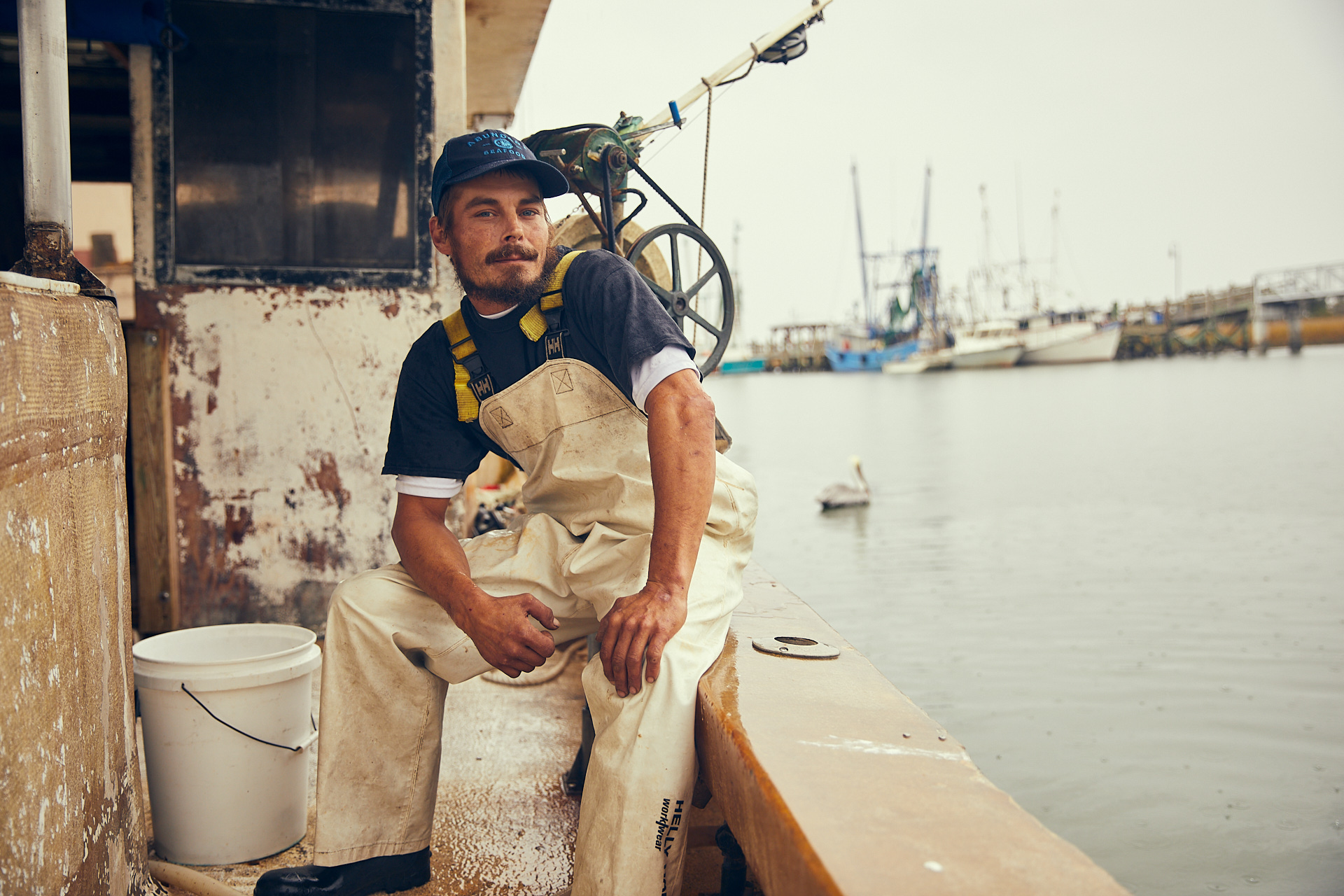 fisherman sitting on his boat at sea brandon clifton atlanta photographer