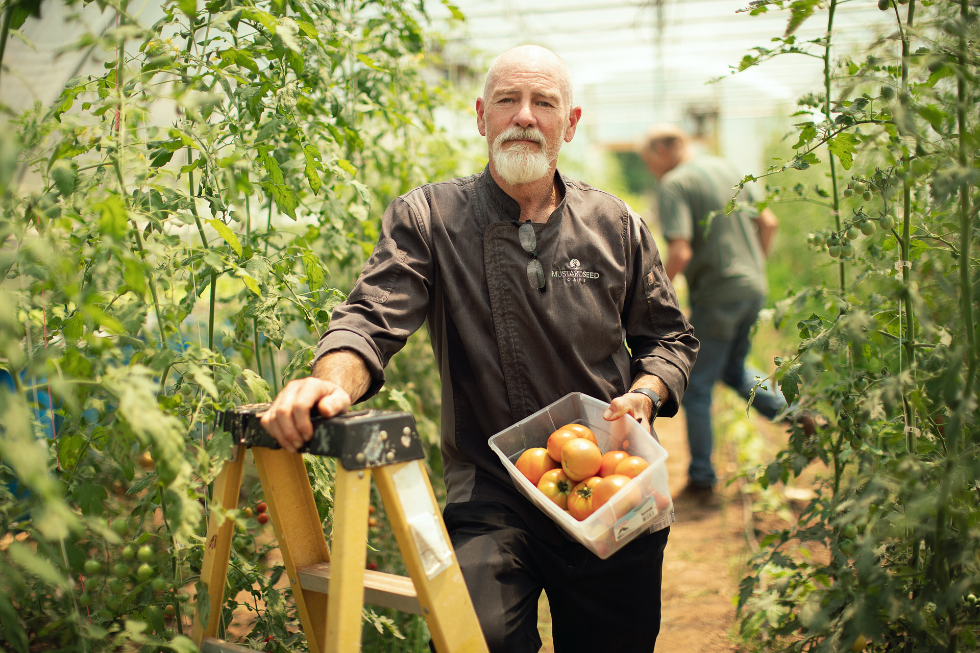 rural farmer holding fresh tomatoes in garden brandon clifton atlanta photographer