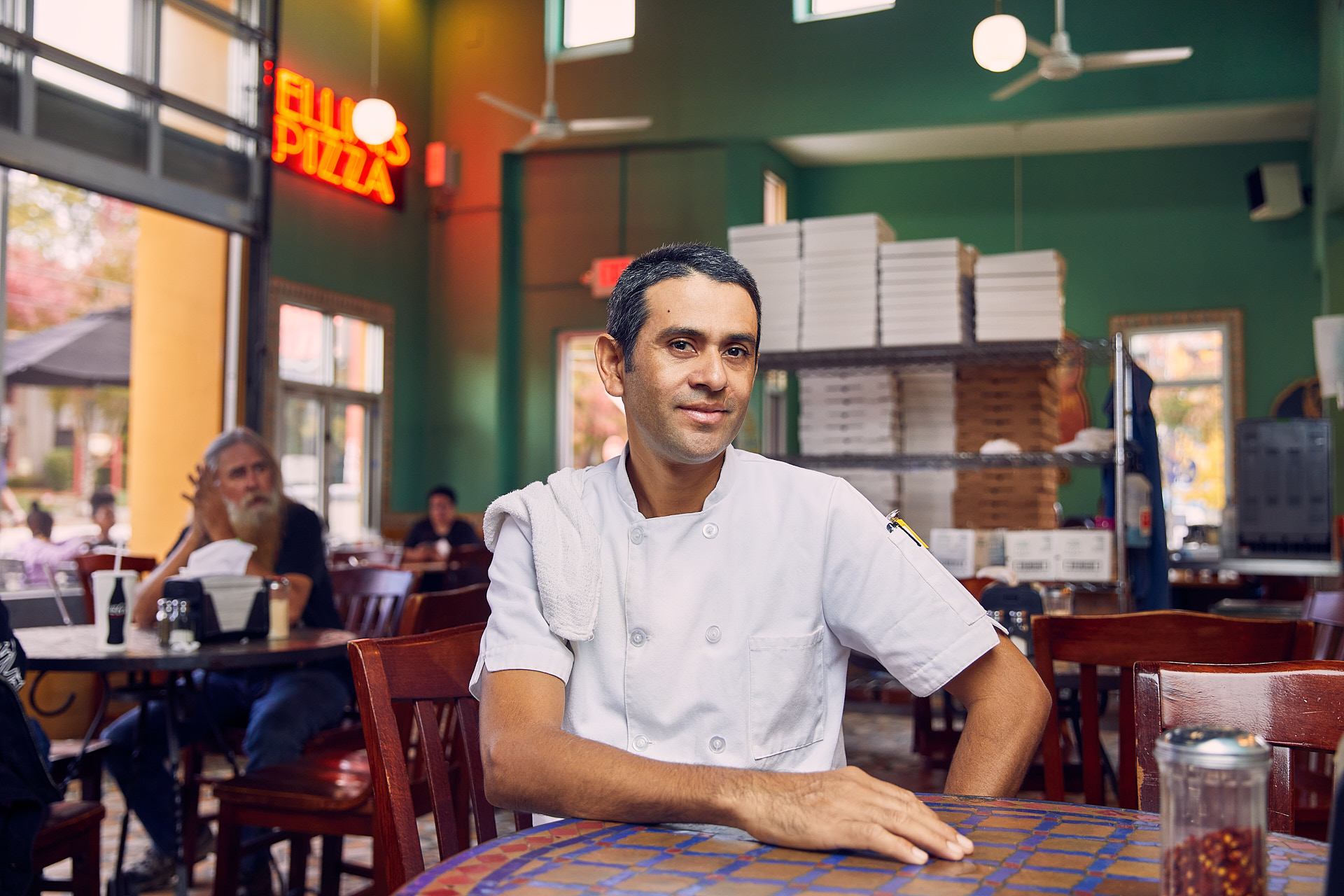 chef sitting in his restaurant brandon clifton atlanta photographer