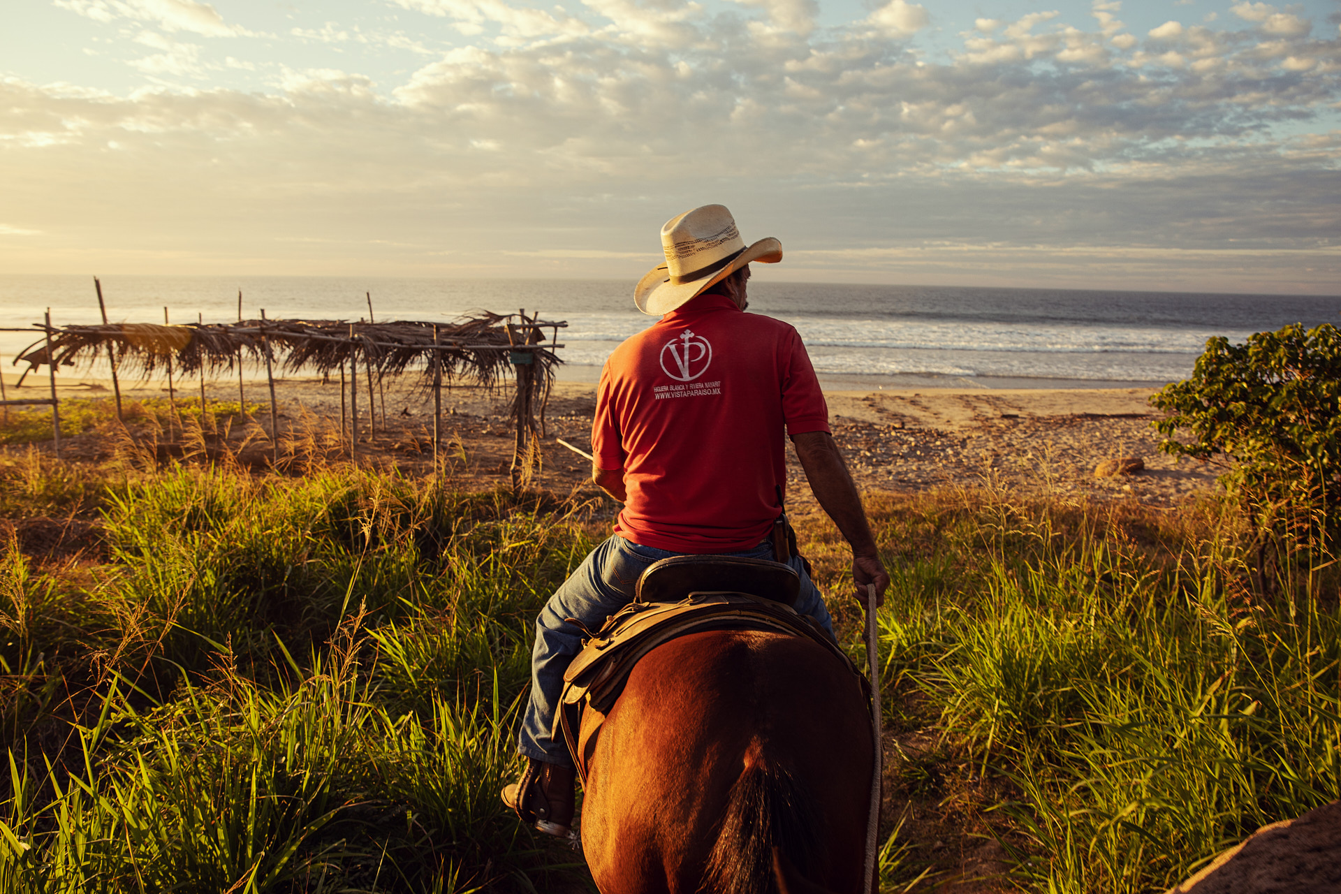 hispanic man on horseback on beach in mexico brandon clifton atlanta photographer